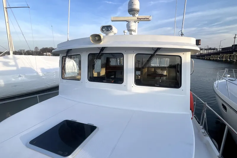 Slide: The Image of 2008 Nordic Tug 42 boat with Raymarine equipment, docked in a marina. - 59