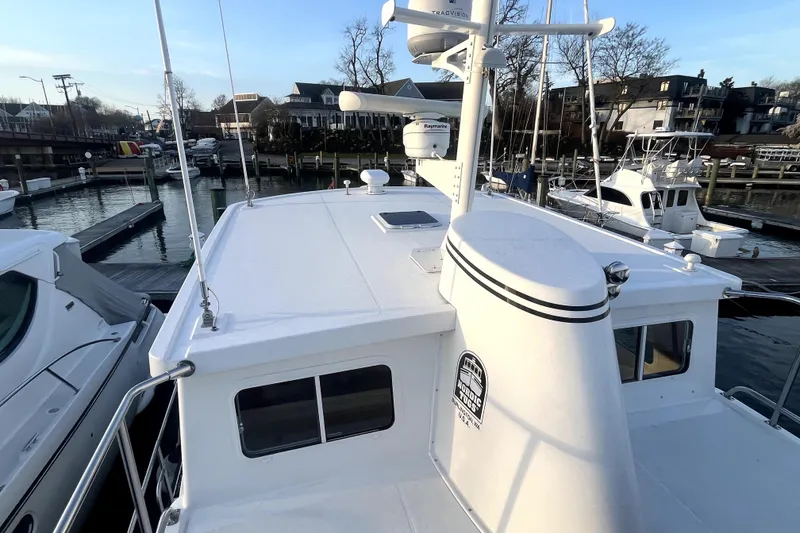 Slide: The Image of Nordic Tug 42 (2008) docked at marina, showcasing upper deck and radar equipment. - 63