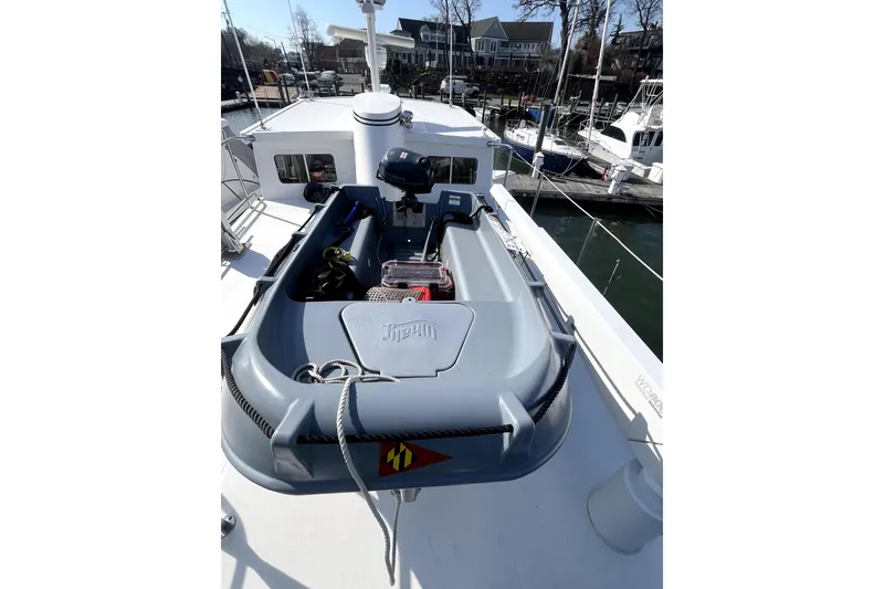 Slide: The Image of 2008 Nordic Tug 42 boat deck with dinghy and motor, docked at marina. - 66