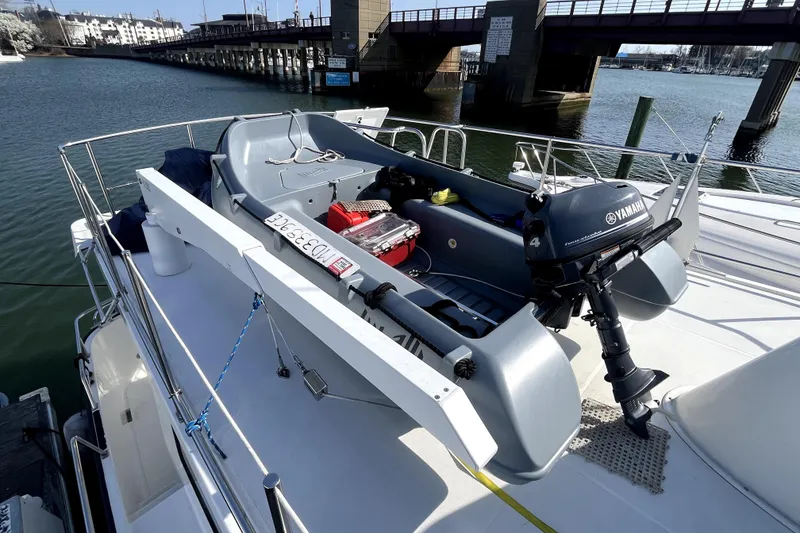 Slide: The Image of 2008 Nordic Tug 42 with Yamaha motorboat on deck, docked near a bridge. - 69