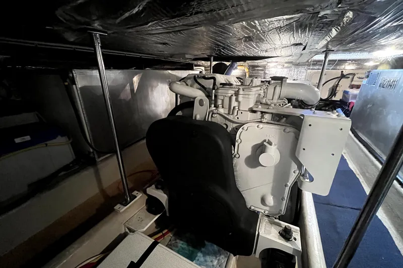 Slide: The Image of Engine room of a 2008 Nordic Tug 42, showcasing mechanical components and insulation. - 71