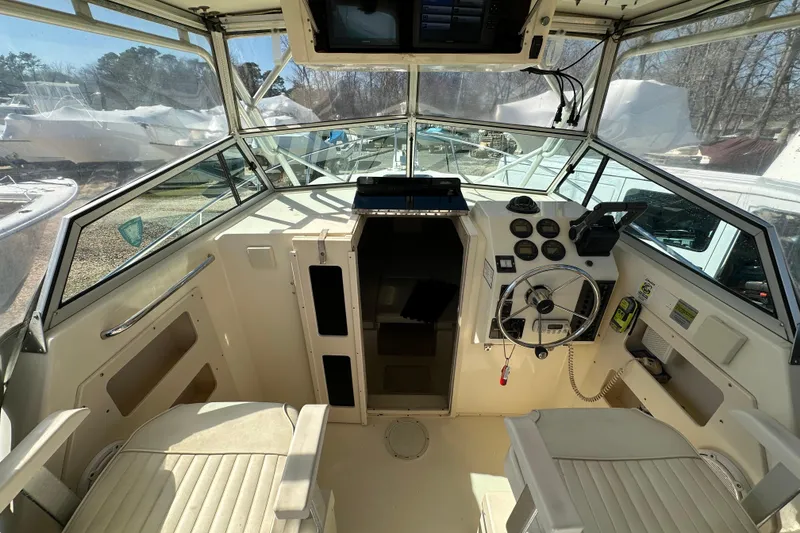 Slide: The Image of 2001 Parker 2510 Deep Vee Walkaround boat interior with steering wheel and dashboard controls. - 11