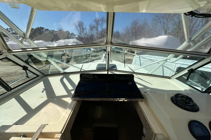 Slide: The Image of 2001 Parker 2510 Deep Vee Walkaround boat interior view with clear windshield. - 12