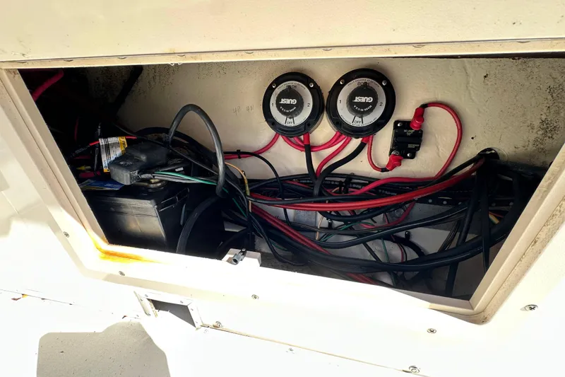 Slide: The Image of Electrical wiring and battery compartment of a 2001 Parker 2510 Deep Vee Walkaround boat. - 13
