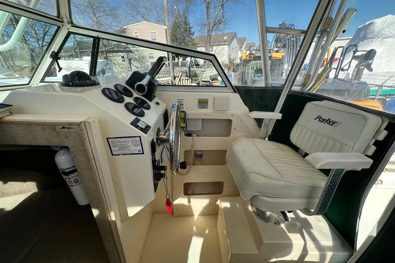 Slide: The Image of 2001 Parker 2510 Deep Vee Walkaround boat interior with helm, gauges, and captain's chair. - 15