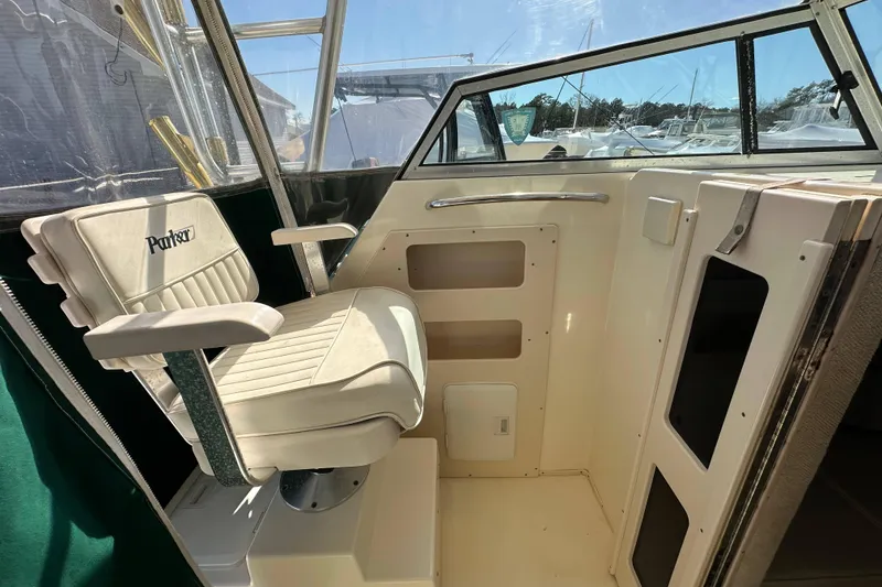 Slide: The Image of 2001 Parker 2510 Deep Vee Walkaround boat interior with captain's chair and dashboard. - 16
