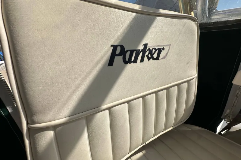 Slide: The Image of Parker 2510 Deep Vee Walkaround 2001 boat seat with logo in sunlight. - 17