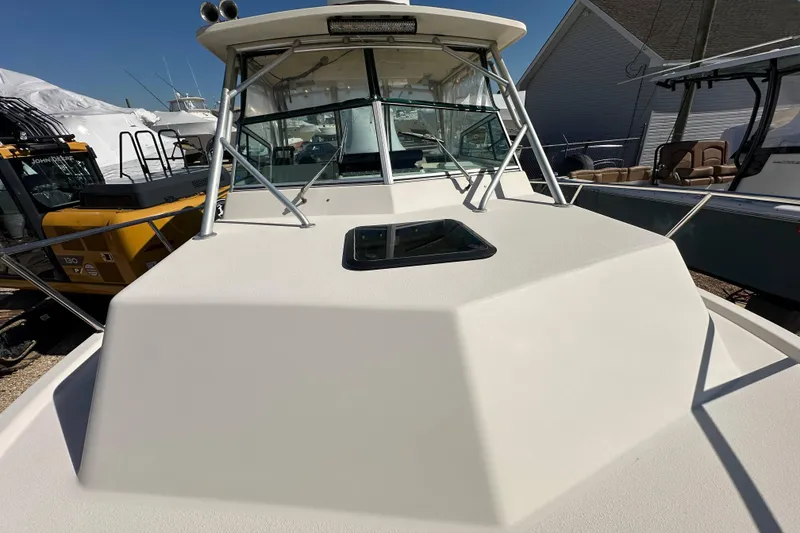 Slide: The Image of 2001 Parker 2510 Deep Vee Walkaround boat, docked with clear skies. - 19