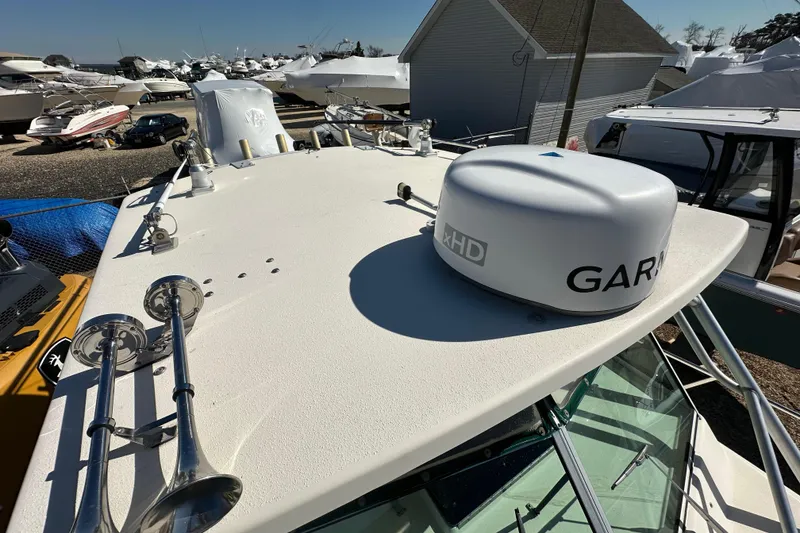 Slide: The Image of 2001 Parker 2510 Deep Vee Walkaround boat with radar and horns on deck. - 23