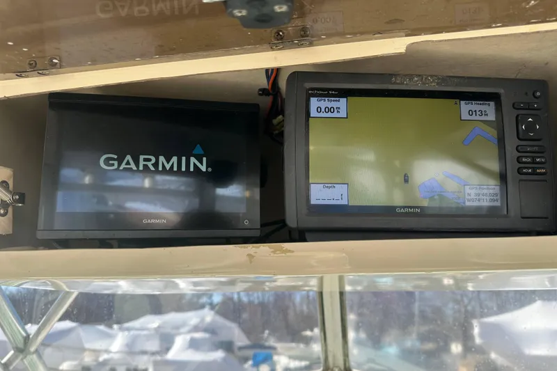 Slide: The Image of Garmin GPS displays on 2001 Parker 2510 Deep Vee Walkaround boat dashboard. - 25