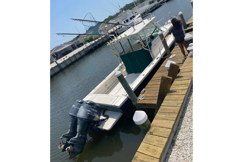 Slide: The Image of 2001 Parker 2510 Deep Vee Walkaround boat docked with dual Yamaha engines. - 5