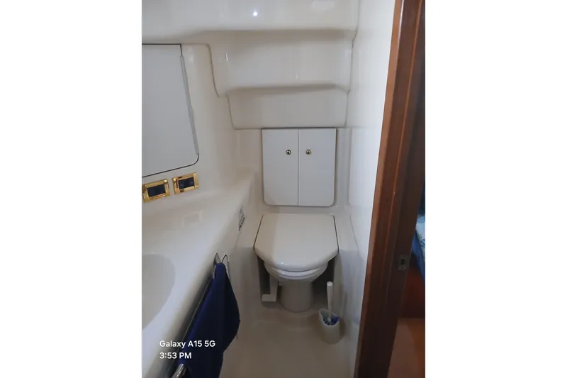 Slide: The Image of Bathroom in 2000 Sea Ray 420 Aft Cabin yacht, featuring compact design and storage cabinets. - 11