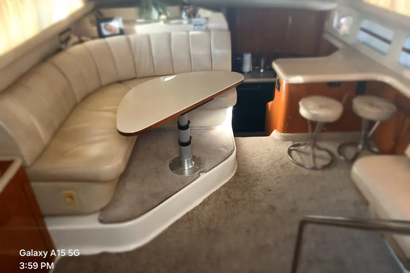 Slide: The Image of Interior of a 2000 Sea Ray 420 Aft Cabin yacht with seating and table. - 12