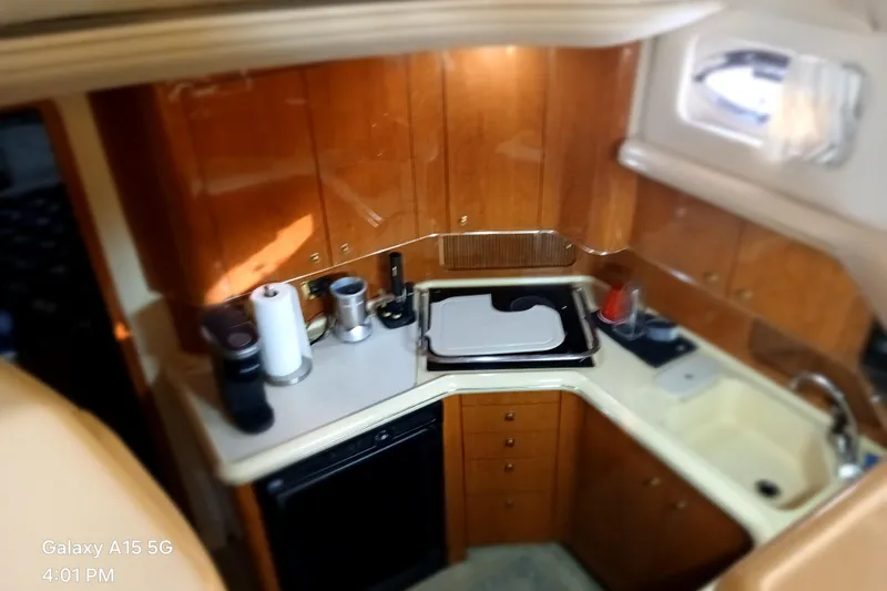 Slide: The Image of Interior of 2000 Sea Ray 420 Aft Cabin yacht kitchen with wooden cabinets and appliances. - 14