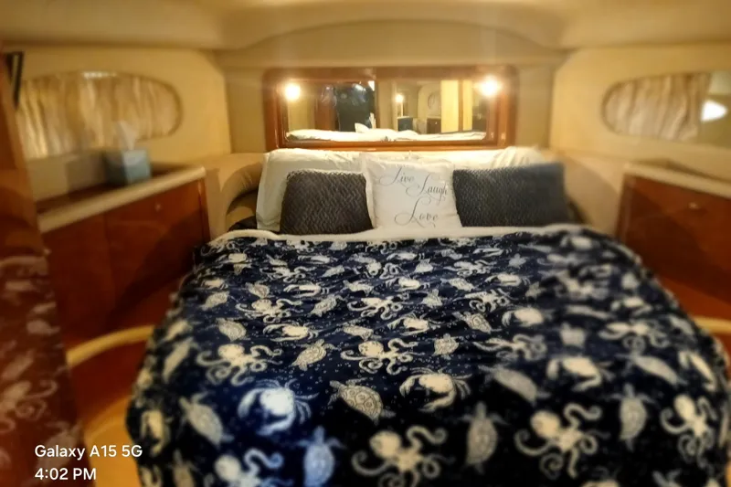 Slide: The Image of Cozy bedroom in 2000 Sea Ray 420 Aft Cabin yacht with nautical-themed bedding. - 18