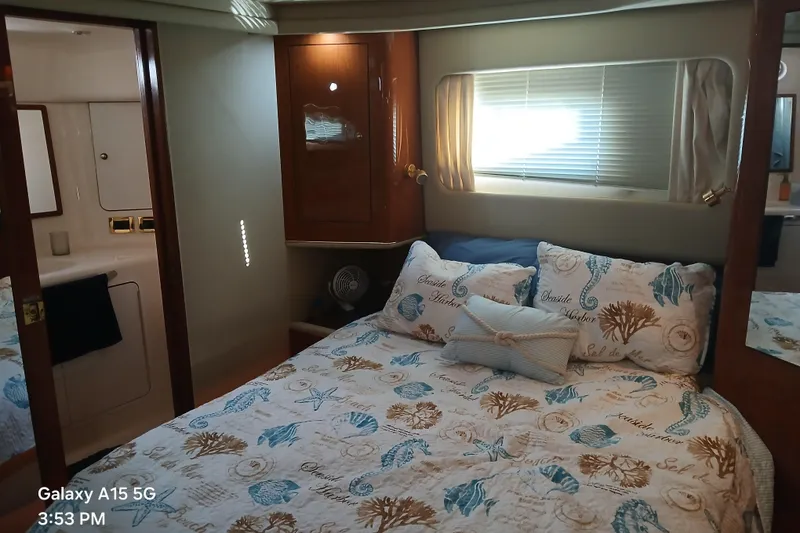 Slide: The Image of Cozy bedroom in 2000 Sea Ray 420 Aft Cabin yacht with nautical-themed bedding. - 7