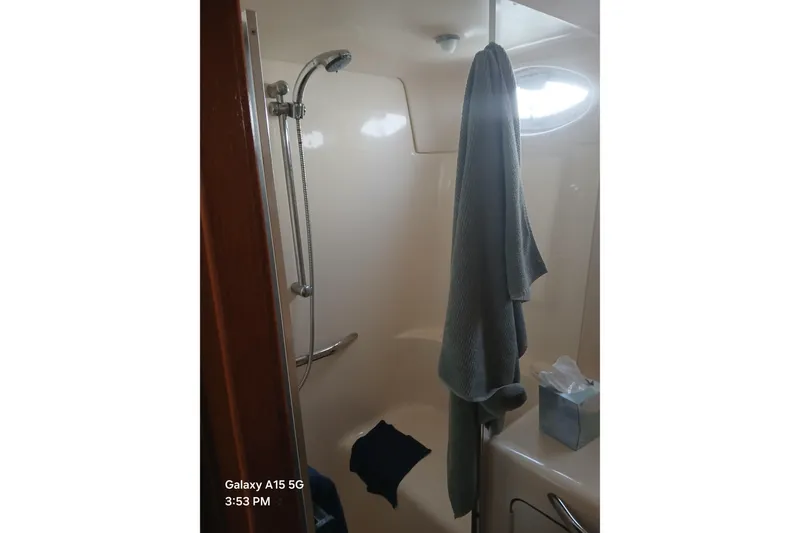 Slide: The Image of Shower area in 2000 Sea Ray 420 Aft Cabin yacht with towel and tissue box. - 9