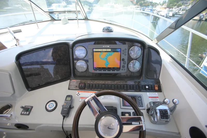 Slide: The Image of Cockpit of 2010 Sea Ray 390 Sundancer with navigation system and controls. - 11