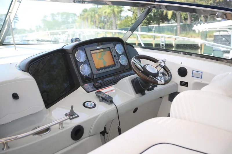 Slide: The Image of Cockpit of 2010 Sea Ray 390 Sundancer with navigation system and steering wheel. - 12