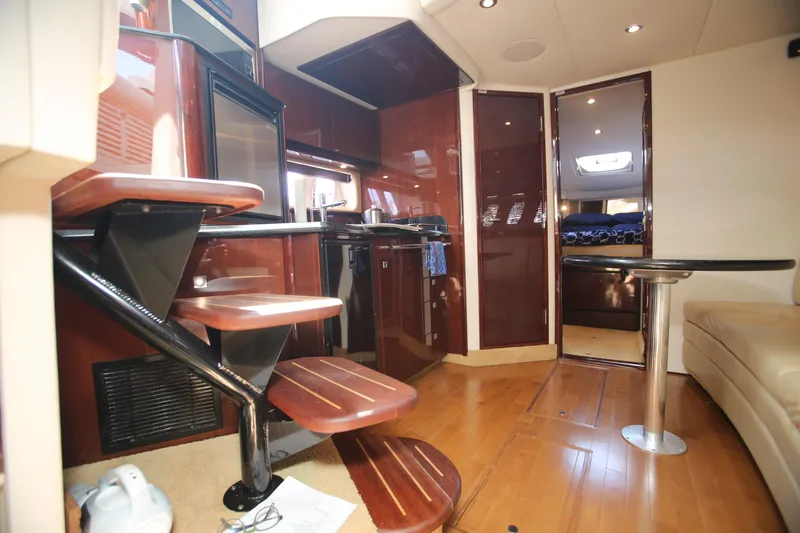 Slide: The Image of Interior of 2010 Sea Ray 390 Sundancer yacht with modern kitchen and wooden stairs. - 18