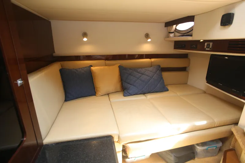 Slide: The Image of Luxurious interior of 2010 Sea Ray 390 Sundancer with beige seating and blue cushions. - 24