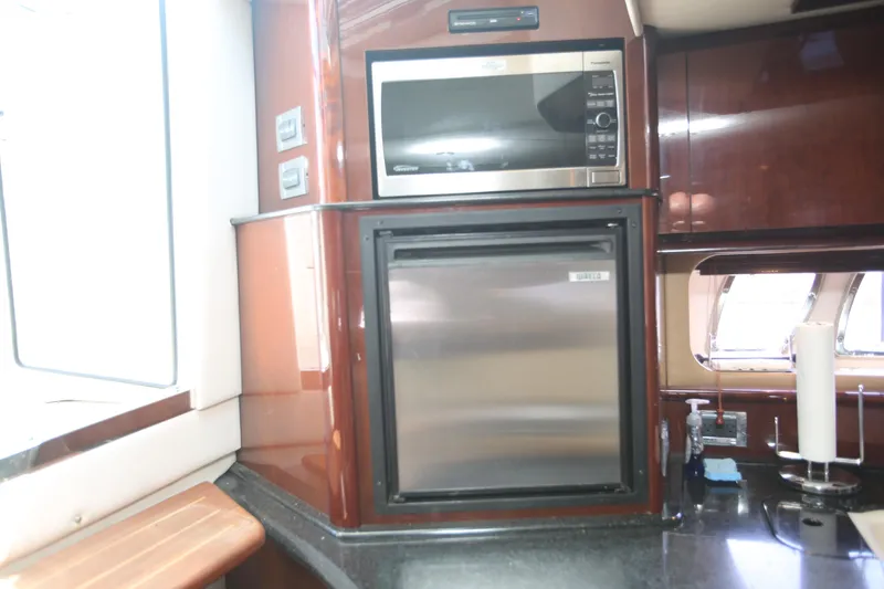 Slide: The Image of Galley area of 2010 Sea Ray 390 Sundancer with microwave and mini-fridge. - 26