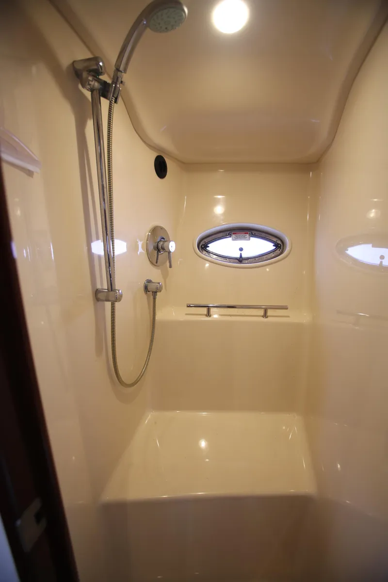 Slide: The Image of Shower area in 2010 Sea Ray 390 Sundancer yacht with porthole and modern fixtures. - 28
