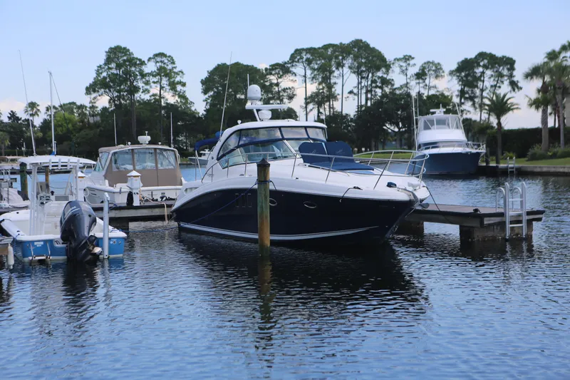 Slide: The Image of 2010 Sea Ray 390 Sundancer yacht docked in a serene marina setting. - 3