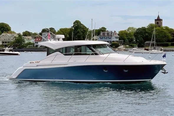 The Image of 2020 Tiara Yachts C39 Coupe cruising on a scenic waterfront. - 0
