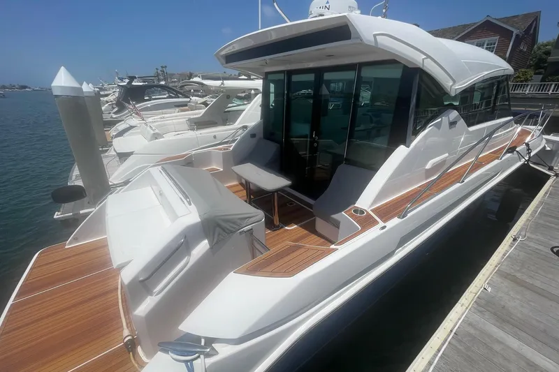 Slide: The Image of 2020 Tiara Yachts C39 Coupe docked, showcasing sleek design and spacious deck. - 2