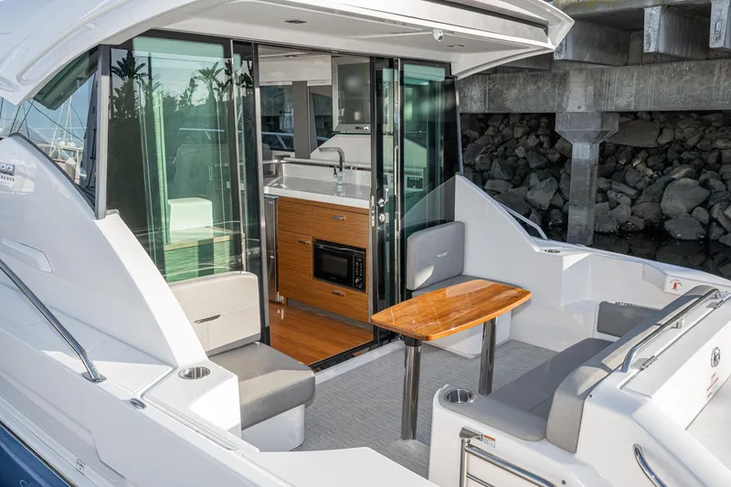 Slide: The Image of 2020 Tiara Yachts C39 Coupe with modern interior and outdoor seating area. - 7