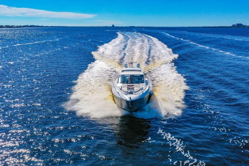 Slide: The Image of 2020 Cruisers Yachts 50 Cantius cruising on open water under clear blue skies. - 10