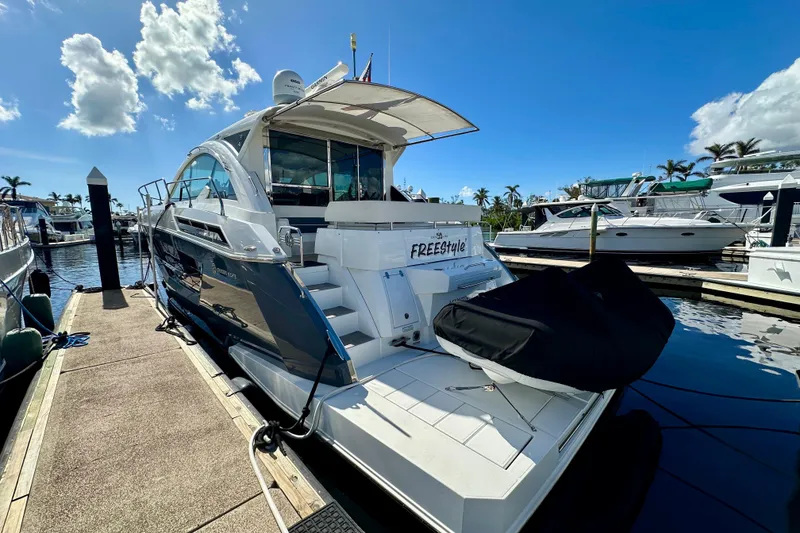 Slide: The Image of 2020 Cruisers Yachts 50 Cantius docked at marina under clear blue sky. - 11