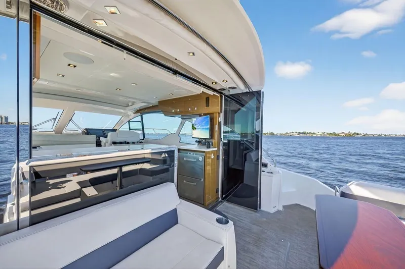 Slide: The Image of 2020 Cruisers Yachts 50 Cantius interior with open deck, modern design, and ocean view. - 13