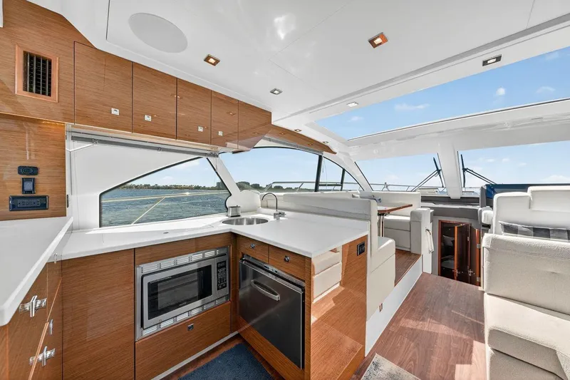 Slide: The Image of Luxurious interior of 2020 Cruisers Yachts 50 Cantius with modern kitchen and seating area. - 23