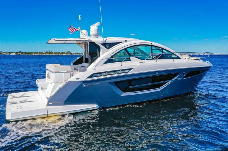 Slide: The Image of 2020 Cruisers Yachts 50 Cantius on open water, sleek design, sunny day. - 4