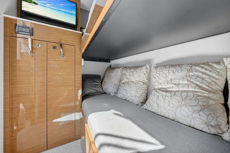Slide: The Image of 2020 Cruisers Yachts 50 Cantius interior cabin with cozy bedding and wall-mounted TV. - 44
