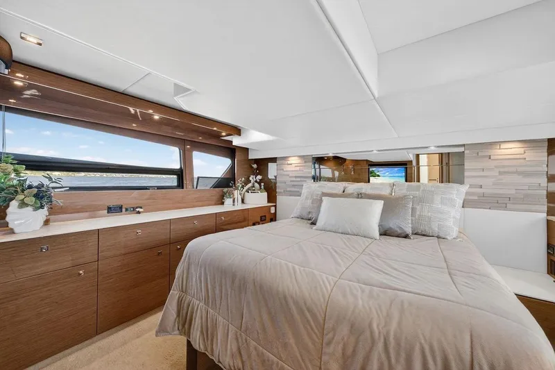 Slide: The Image of Luxurious 2020 Cruisers Yachts 50 Cantius bedroom with elegant wood finishes and large windows. - 51