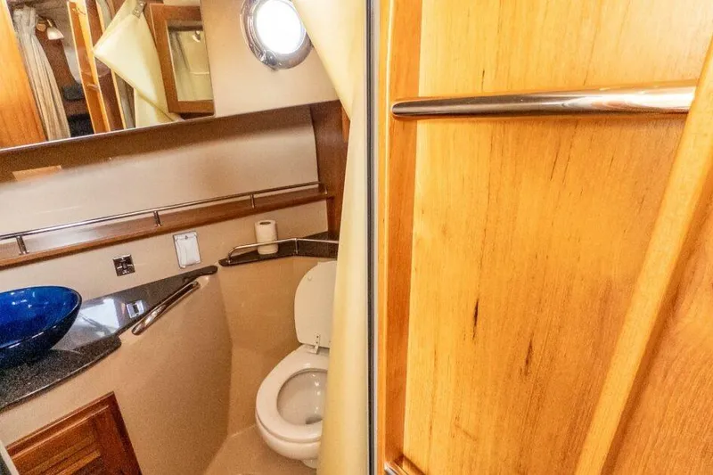 Slide: The Image of 2019 Ranger Tugs R-31-S bathroom with wooden accents and modern fixtures. - 12