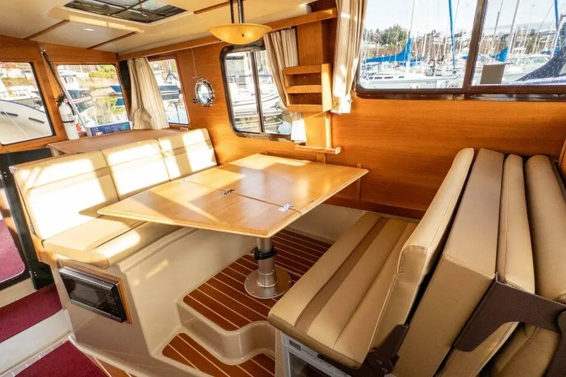 Slide: The Image of Interior of 2019 Ranger Tugs R-31-S with dining area and wooden accents. - 20