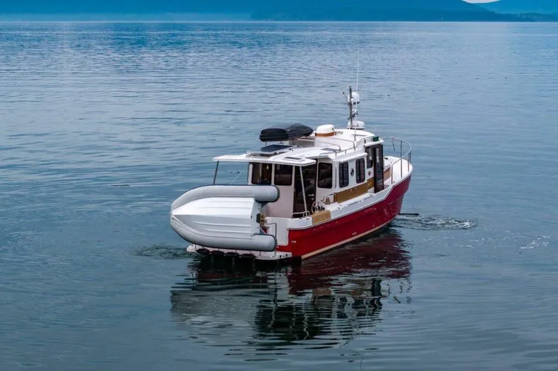 Slide: The Image of 2019 Ranger Tugs R-31-S boat cruising on calm water. - 3