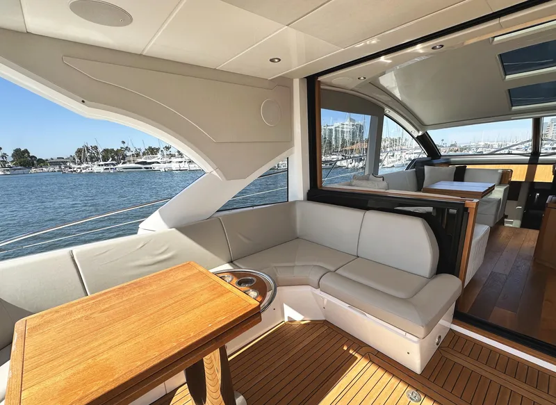 Slide: The Image of Luxurious 2019 Sunseeker Predator 57 yacht interior with elegant seating and scenic marina view. - 7