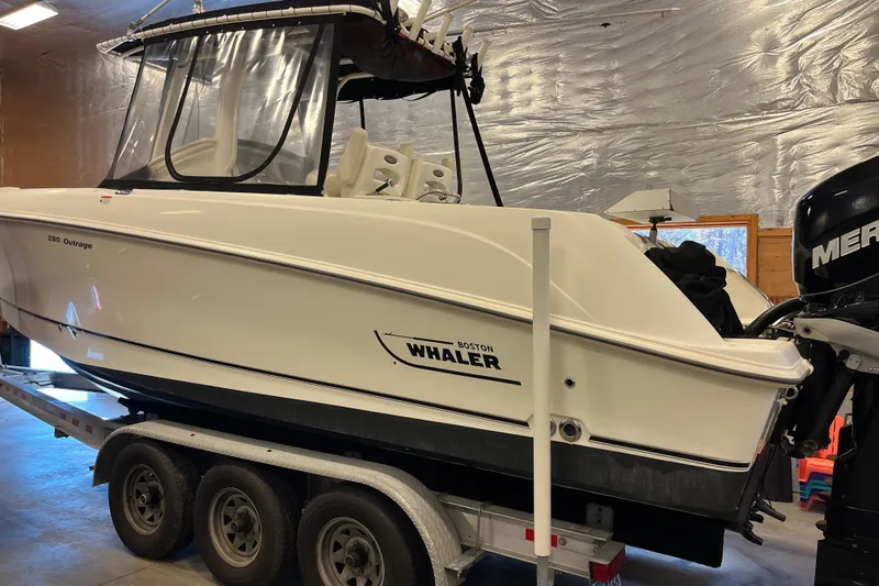 Slide: The Image of 2014 Boston Whaler 280 Outrage boat on trailer in indoor storage. - 10