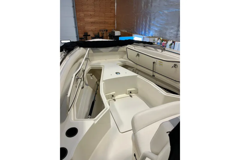 Slide: The Image of 2014 Boston Whaler 280 Outrage boat interior with seating and storage compartments. - 2