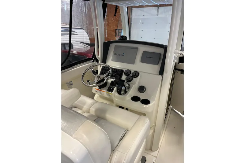 Slide: The Image of 2014 Boston Whaler 280 Outrage helm with Garmin displays and steering wheel. - 3