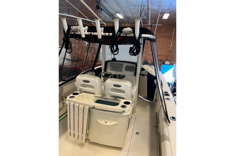 Slide: The Image of 2014 Boston Whaler 280 Outrage boat interior with helm and fishing rod holders. - 4