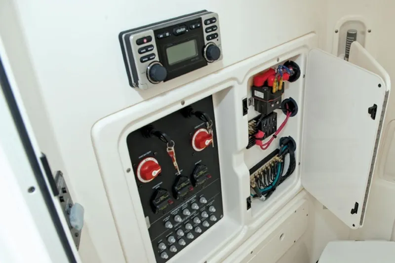 Slide: The Image of Manufacturer Provided Image: 2014 Boston Whaler 280 Outrage boat interior with control panel and toilet. - 7