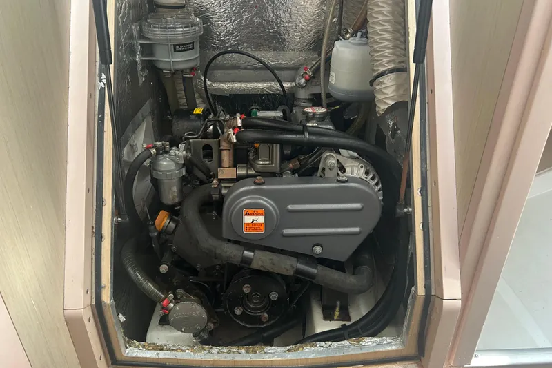 Slide: The Image of Engine compartment of a 2020 Beneteau Oceanis 30.1 sailboat, showcasing mechanical components. - 12
