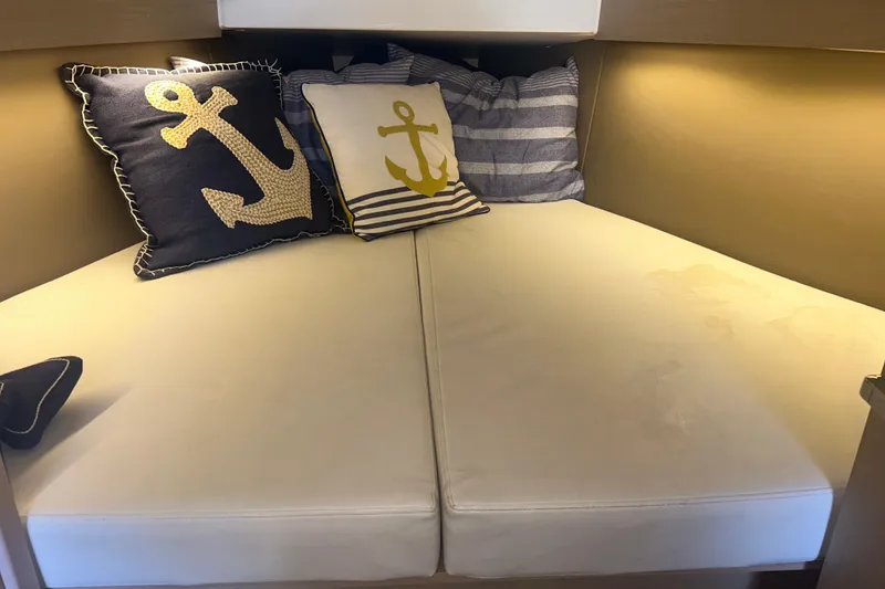 Slide: The Image of Cozy cabin interior of 2020 Beneteau Oceanis 30.1 with nautical-themed pillows. - 8