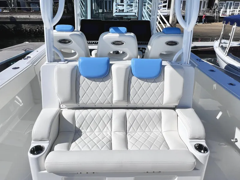 Slide: The Image of Luxury seating on 2018 HCB 39 Speciale boat with blue accents and cup holders. - 12
